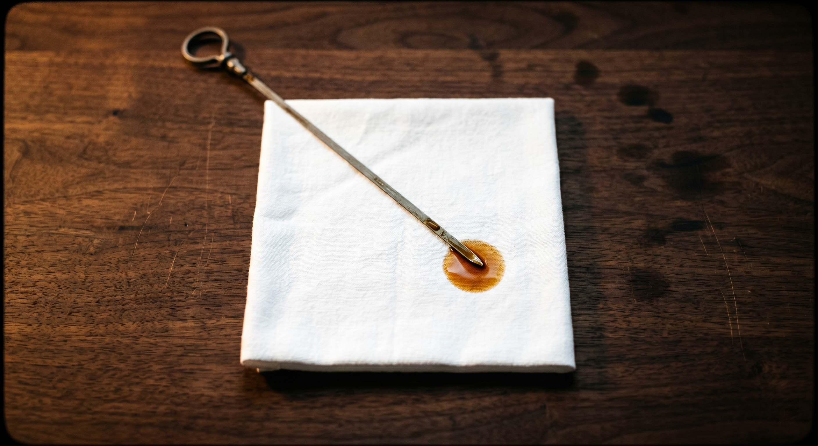 Close-up of a hand pulling an oil dipstick from an engine bay with amber oil visible between the low and high marks